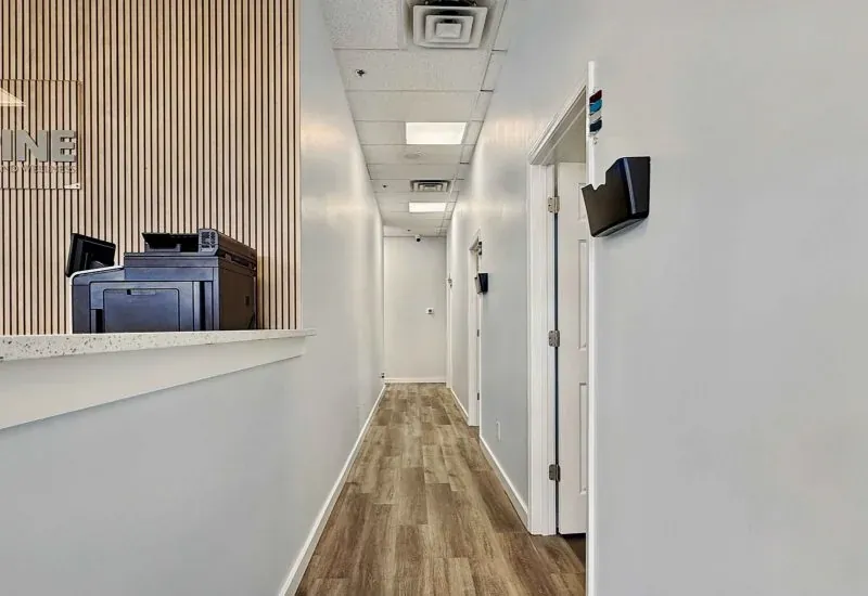 Hallway leading to the treatment rooms at the Calhoun clinic, past the check-in counter.